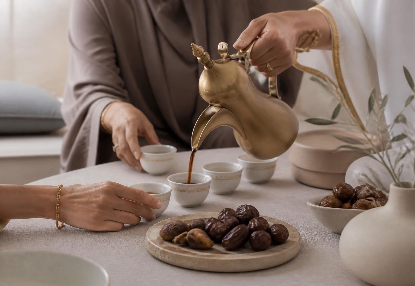 Coffee poured from a brass pot into small cups at a shared table